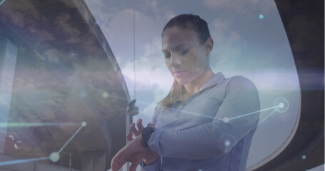 Poster - image of network of connections and sky with clouds over caucasian woman using smartwatch