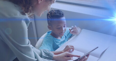 Poster - Image of light trails over diverse schoolboy and teacher using tablet