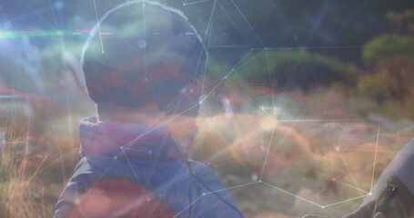 Poster - Image of network of connections and sky with clouds over caucasian man using tablet