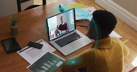 Poster - image of spinning globe over african american woman having a image call on laptop at home