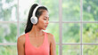 © weedezign - young healthy asian woman listening music while practice yoga at home