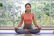 © weedezign - young healthy woman practice yoga mudra on a mat at home, in a yoga sitting position