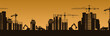 © Богдан Скрипник - City skyline at sunset featuring building silhouettes with cranes in a construction scene.