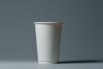 Poster - White Paper Cup on Gray Background, Symbolizing Coffee Break and Sustainable Packaging Solutions for the Food Industry : Generative AI