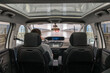 © puhimec - Car interior with panoramic roof. Driver in rain. Rear view.