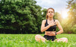© Barillo_Images - Healthy woman practising breathing exercise in lotus pose in urban park