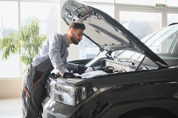 Fototapete - Troubleshooting process. Auto mechanic working in garage. Repair service