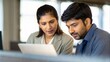 © N7 - Indian professionals working together on financial analysis using digital reports and graphs