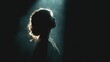 © Justlight - Profile of a young woman illuminated by a dramatic, cinematic light beam, creating a silhouette against a dark background, symbolizing hope, revelation, or spiritual awakening