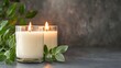 © kirania - Two illuminated candles on a dark surface with greenery.