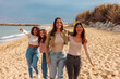 © bernardbodo - Female friend group walking down a sandy beach