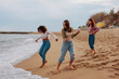 © bernardbodo - Three friends having fun by ocean