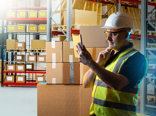 Poster - Man warehouse manager. Storekeeper with e-tablet. Warehouse manager scratching chin. Frowning supervisor doing inventory in warehouse. Man standing in factory storage area. Storekeeper in uniform