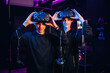 © standret - Taking off the eyewear. Two young men in virtual reality glasses indoors