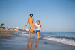 © sutulastock - Mother and Son Running Together on a Sunny Beach