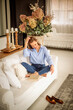 © sepy - Brunette haired middle aged woman relaxing at home on the couch