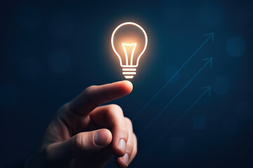 Poster - A reaching out towards an illuminated bulb symbolizes the spark innovation driving growth and strategic progress in business