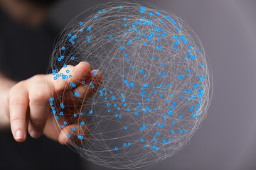 Leinwandbilder - Abstract image of a hand interacting with a digital sphere representing global networking and connectivity.