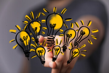 Aufkleber - Hand holding multiple glowing lightbulbs,concepts of innovation, creativity, and teamwork.