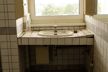 Poster - Stock photo of a grungy bathroom sink, showing signs of age and neglect.  Ideal for articles on home renovation or cleaning.