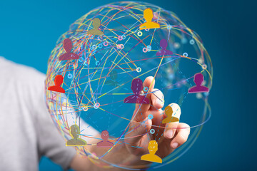 Fototapete - Hand interacting with a digital globe showing interconnected people, symbolizing global networking and communication.