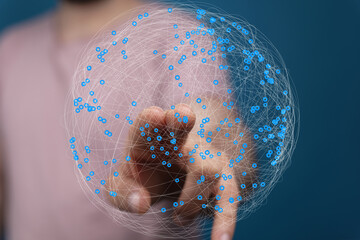 Fototapete - Abstract image of a hand interacting with a digital sphere representing global network connections.