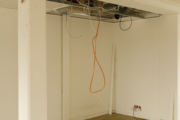 Poster - Stock photo of an interior room under construction, showing exposed wiring and unfinished drywall.