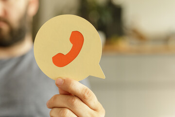 Poster - Image of a person holding a speech bubble with a phone icon. Perfect for contact us pages and customer service.