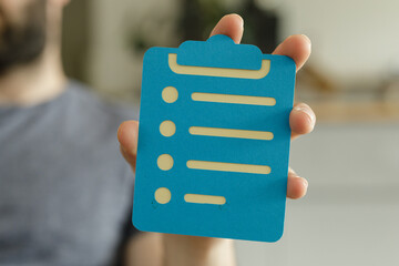 Aufkleber - Person holding a blue checklist clipboard.  Perfect for planning, to-do lists, organization.