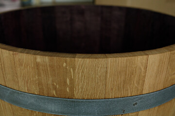 Poster - Close-up of a rustic wooden barrel, featuring a metal band and dark interior. Perfect for rustic decor.