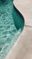 Poster - Turquoise pool water glistening under sunlight, curved concrete edge reflecting bright summer radiance and tranquil swimming environment