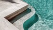 © Newleks - Bright sunlight casting golden reflections on crystal clear turquoise pool water, highlighting polished travertine marble steps with serene, luxurious ambiance