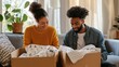 © Andrei - Happy couple unpacking boxes and discovering baby clothes in new home