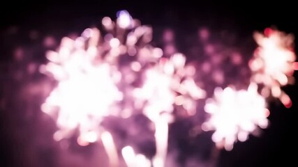 Poster - Blurred bokeh effect of colorful fireworks exploding in night sky. Abstract celebration light show defocased festive event.