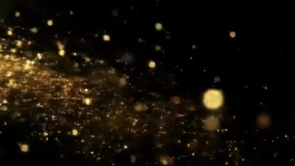 Poster - A stream of golden glitter and light particles moving across a dark background. Abstract magic and celebration concept footage.
