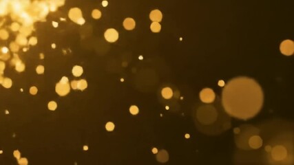 Poster - Golden shimmering particles move and sparkle against a dark background. Abstract bokeh light effect for festive and luxurious visuals.