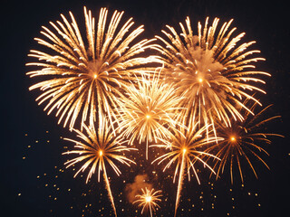 a vibrant photograph capturing multiple golden fireworks exploding in the dark night sky, creating a