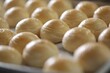 © Chanin - Toasted Mung Bean Cake from the oven. Chinese pastry or moon cake filled with sweet mung bean paste and salted egg yolk. Delicious pastry.