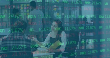 Poster - Woman writing notes in tech meeting and gesturing to colleague while stock ticker overlay updating