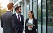 © lian - Businesspeople having conversation in front of office building. High quality