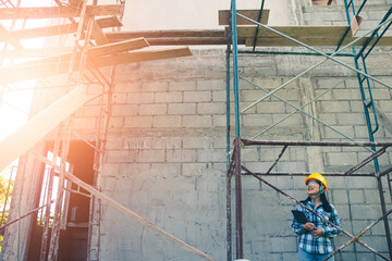 Wall Mural - Female engineer ensuring safety standards during housing project site visit.