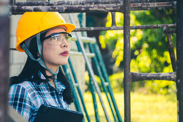 Wall Mural - Female engineer ensuring safety standards during housing project site visit.