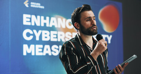 Poster - Businessman, presentation or seminar with tablet or mic for speech or cybersecurity convention. Man, employee or speaker with technology display for online safety measures or tradeshow at tech summit