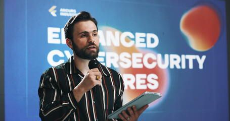 Poster - Businessman, tablet and presentation with mic for seminar or cybersecurity convention at workplace. Man, speaker or presenter talking with technology for online safety measures or awareness campaign