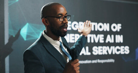 Poster - Black man, presentation or seminar with mic or screen for speech or AI convention at workplace. Businessman, presenter or speaker with technology display for online service, tradeshow or tech summit