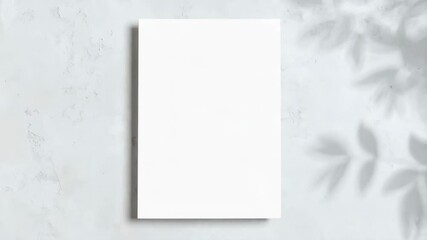 Poster - Blank white paper sheet against textured wall with leafy shadows, clean template for text placement, advertisement