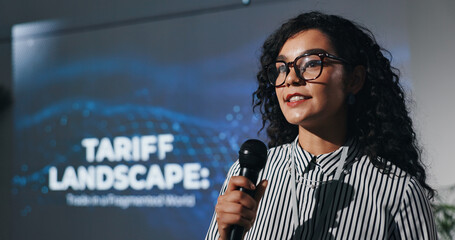 Poster - Microphone, seminar and speech with business woman in auditorium for presentation in tariff landscape. Development, symposium and workshop with guest speaker on podium or stage for tax conference