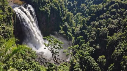 Aufkleber - Majestic valley waterfall in lush tropical forest, vibrant green landscape, powerful flow, mist rising, peaceful nature