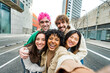 © Davide Angelini - Happy multiracial friends having fun on city street - Group of young people smiling at camera outside - Friendship concept with guys and girls walking in downtown road