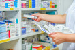 © I Viewfinder - Pharmacist filling prescription in pharmacy drugstore